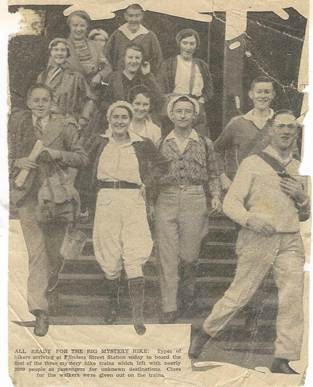 Newspaper clipping: 'All Ready for the Big Mystery Hike' — group on steps at Flinders Street Station ready to board the Mystery Express, c.1930s