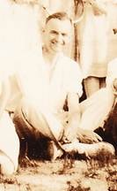 Robertson family man seated outdoors, smiling — small sepia portrait, c.1920s–1930s