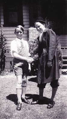 Rod Rowe and Tim Webber at Korumburra — outdoor snapshot, two boys standing together on lawn shaking/holding hands, brick building behind