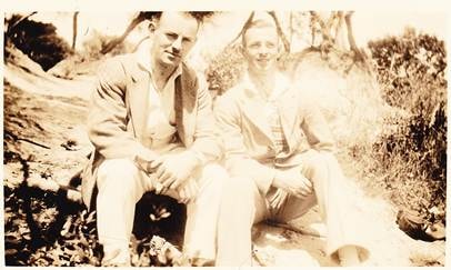 Robertson/Webber family — man and woman sitting together outdoors on rocks or hillside, sepia, c.1930s