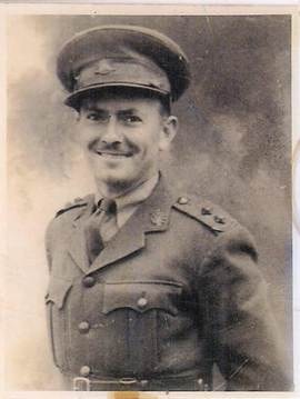 Bob Webber — outdoor snapshot, Bob in Australian Army uniform (khaki jacket, peaked cap) seated on front steps/wall of brick house