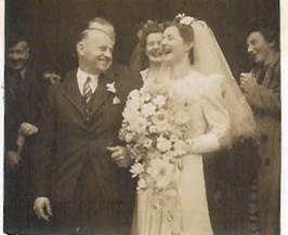 Robertson/Webber family wedding — man and bride walking together outside church, guests behind, c.1940s