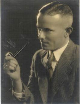 Robertson/Webber family young man in pinstripe suit holding a pipe, sepia studio portrait, c.1930s