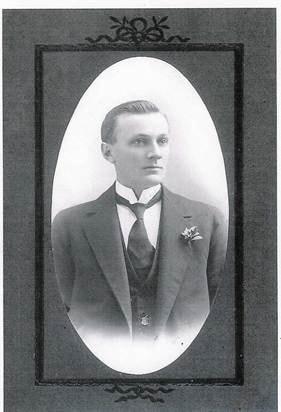 Robertson family young man — formal oval-framed studio portrait, suit with boutonnière, c.1900s–1910s