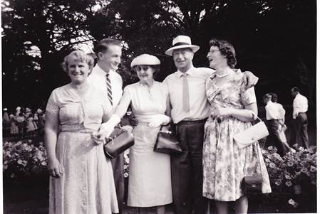 Rowe family — five people at an outdoor gathering, trees behind, c.1950s–1960s